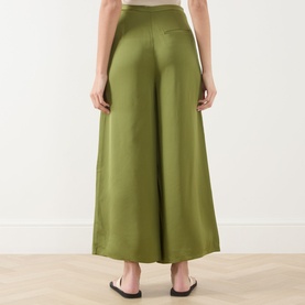 Model wearing Marc O Polo Shaded Fern wide-leg satin-finish viscose trousers, rear view, styled with black flat sandals.