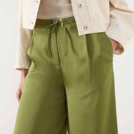 Model wearing Marc O Polo Shaded Fern wide-leg drawstring trousers in viscose, styled with a cream jacket.