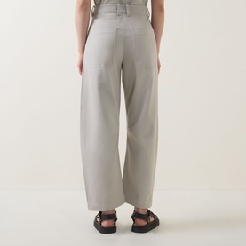 Model wearing Marc O Polo Linen Beige wide-leg trousers, rear view, styled with black strappy sandals