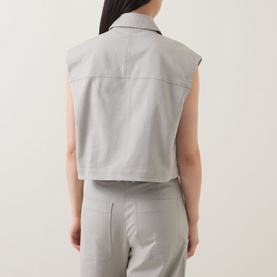 Model wearing Marc O Polo Linen Beige cotton vest, back view, styled with matching wide-leg trousers