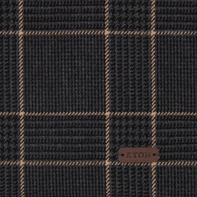 Eton Prince of Wales Check Scarf in black, close-up of wool fabric showing tan check pattern and leather logo patch