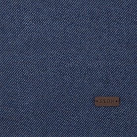 Eton Logo Twill Fringe Scarf in blue wool, close-up showing diagonal twill weave texture and brown leather logo plaque