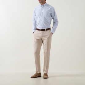 Model wearing Eton mid blue cotton casual shirt with button-down collar, styled with stone chinos and brown belt.