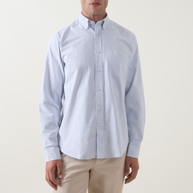 Model wearing Eton mid blue striped cotton casual shirt with button-down collar and chest pocket, styled with stone chinos