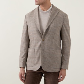Model wearing Eton beige glen check blazer jacket, styled with a grey crew-neck and brown trousers