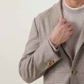 Model wearing Eton beige check blazer jacket, styled with a light grey crew-neck top, gold-tone buttons at cuff visible
