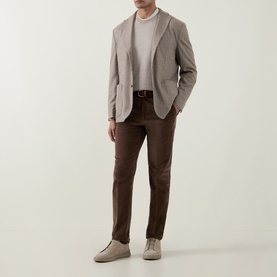 Model wearing Eton beige jacket with white T-shirt, brown trousers and grey suede shoes.