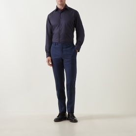 Model wearing Eton Navy Geo Trim Single Cuff Regular shirt with navy tailored trousers and black dress shoes.