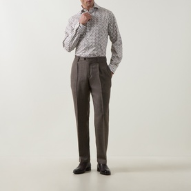 Model wearing Eton Brown Single Cuff Regular cotton shirt with small print, styled with taupe pleated trousers and dark Oxford shoes.