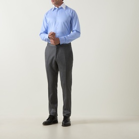 Model wearing Eton Signature Striped Shirt in mid blue with pointed collar, styled with grey tailored trousers and black dress shoes.