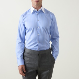 Model wearing Eton Signature Striped Shirt in mid blue pinstripe with white pointed collar, slim fit, styled with grey trousers.