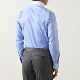 Model wearing Eton Signature Striped Shirt in mid blue pinstripe, rear view, slim fit, buttoned cuff, styled with grey trousers