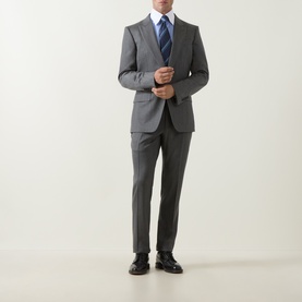 Model wearing Eton Signature Striped Shirt in mid blue, styled with grey suit, blue striped tie and black Oxford shoes.