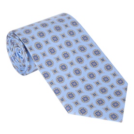 Eton Medallion Silk Tie in light blue with repeat geometric medallion print, rolled to show wide blade and pointed tip