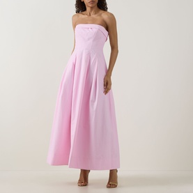 Model wearing Jonathan Simkhai Avril Bustier Dress in Daisy pink, strapless maxi with pleated skirt and fitted bodice, styled with strappy heels