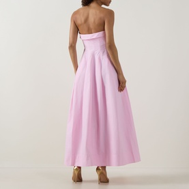 Model wearing Jonathan Simkhai Avril Bustier Dress in Daisy pink, strapless maxi length with pleated skirt and fitted bodice, back view