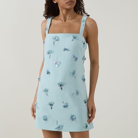 Model wearing Jonathan Simkhai Ella Embellished Mini Dress in blue with floral embellishments, square neckline and fixed shoulder straps