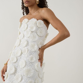Model wearing Jonathan Simkhai Holland Floral Raffia Bustier Mini Dress in white with 3D floral raffia embellishment, strapless straight neckline