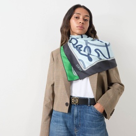 Model with Loewe Anagram Logo Reversible Belt in Tan/Black, gold-tone buckle, styled with a printed scarf and blazer.