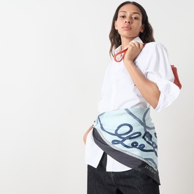 Model with Loewe Silk Printed Square Scarf in navy and green, worn as a belt, styled with a white oversized shirt and dark jeans.