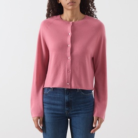 Model wearing Marc O Polo Berry Rose wool cardigan with round neck, button front, and cropped fit, styled with blue jeans.