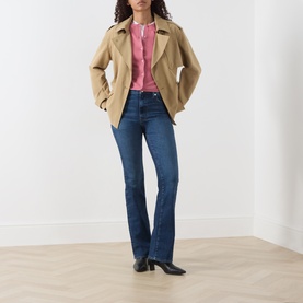 Model wearing Marc O Polo Berry Rose cardigan, styled with camel jacket and dark blue bootcut jeans.