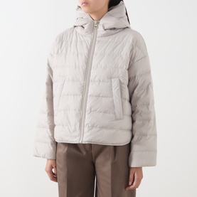 Model wearing Marc O Polo Linen Beige quilted hooded puffer coat with zip fastening, styled with brown wide-leg trousers.