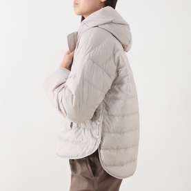 Model wearing Marc O Polo Linen Beige quilted hooded coat with curved hem, styled with taupe trousers
