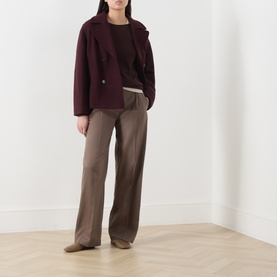 Model wearing Marc O Polo Black Cherry wool jacket, styled with brown knit top and wide-leg taupe trousers