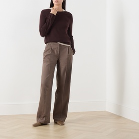 Model wearing Marc O Polo Black Cherry virgin wool knit with wide-leg taupe trousers and tan suede boots.