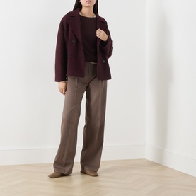 Model wearing Marc O Polo Black Cherry wool knit jacket, styled with taupe wide-leg trousers and nude heeled mules