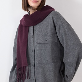 Model with Marc O Polo Black Cherry wool scarf with fringed ends, styled over a grey button-up coat.