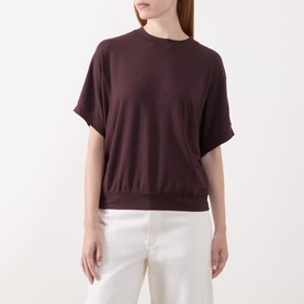 Model wearing Marc O Polo Black Cherry T-Shirt with short sleeves and ribbed hem, styled with white wide-leg trousers