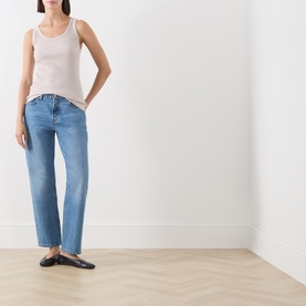 Model wearing Marc O Polo Natural cotton modal vest top with light blue straight-leg jeans and black flat mules.