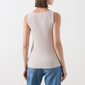 Model wearing Marc O Polo Natural ribbed sleeveless top, back view, styled with blue jeans.