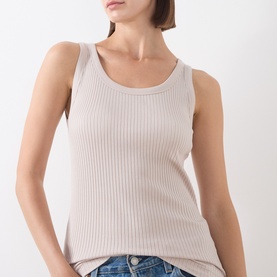 Model wearing Marc O Polo natural ribbed sleeveless tank top with scoop neck, styled with blue denim jeans