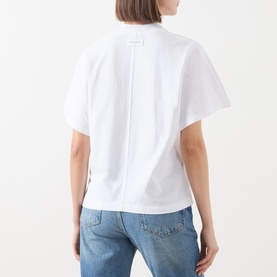 Model wearing Marc O Polo white cotton T-shirt, rear view showing centre back seam detail, styled with blue jeans