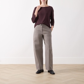 Model wearing Marc O Polo Black Cherry long-sleeve T-shirt, styled with wide-leg grey trousers and black loafers.