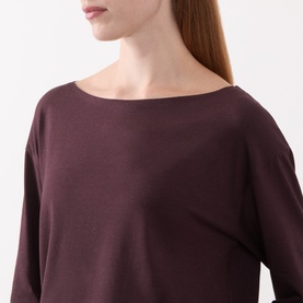 Model wearing Marc O Polo Black Cherry T-Shirt with boat neckline and long sleeves in modal cotton blend.