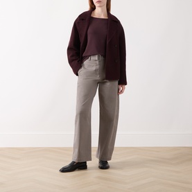 Model wearing Marc O Polo Black Cherry T-Shirt, styled with a dark burgundy jacket and taupe wide-leg trousers, black loafers.