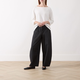 Model wearing Marc O Polo White Cotton T-Shirt with wide-leg black trousers and black ballet flats.