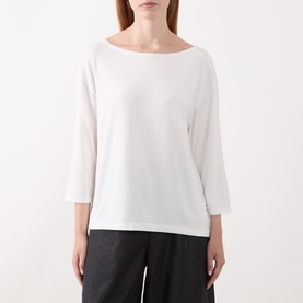 Model wearing Marc O Polo White Cotton T-Shirt with boat neckline and three-quarter sleeves, styled with dark wide-leg trousers.