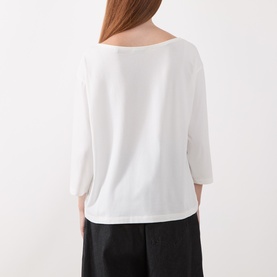 Model wearing Marc O Polo White Cotton T-Shirt, back view, with cropped black trousers. Relaxed fit with 3/4 sleeves and wide neckline.