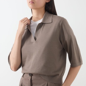 Model wearing Marc O Polo Stone Taupe knit polo top with open V-neck collar and short sleeves, styled with matching trousers
