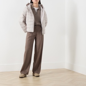Model wearing Marc O Polo Stone Taupe wool top, styled with a light quilted gilet and wide-leg brown trousers.