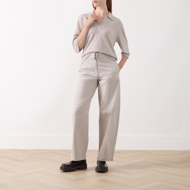 Model wearing Marc O Polo Natural wool top with V-neck collar, styled with matching wide-leg trousers and black loafers.