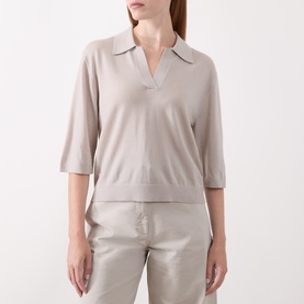 Model wearing Marc O Polo Natural knit polo top with V-neck collar and short sleeves, styled with taupe trousers.