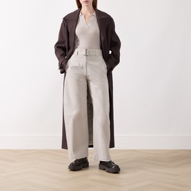 Model wearing Marc O Polo Natural wool top with wide-leg cream trousers, dark brown longline coat and black chunky loafers.