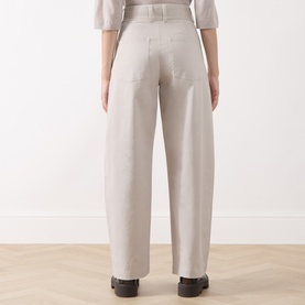 Model wearing Marc O Polo natural wide-leg trousers, rear view, styled with a light blouse and black loafers