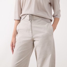 Model wearing Marc O Polo natural wide-leg trousers with silver buckle belt detail, styled with a matching beige top